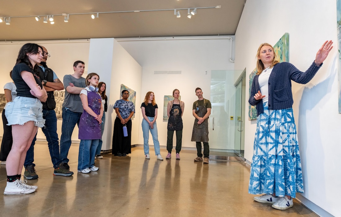 Student talking about her work in a gallery