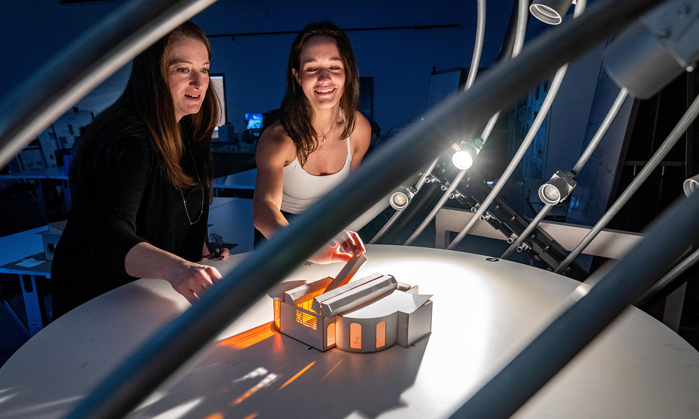 Students in a lighting for interior design class work with the heliodon