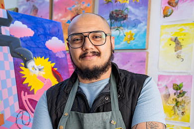 student painter in front of canvases