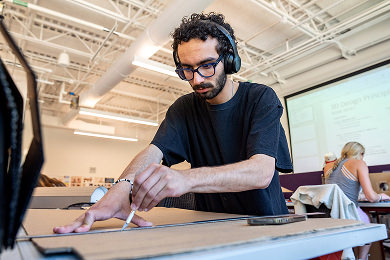 Student in a 3D design principles class works on projects in a studio