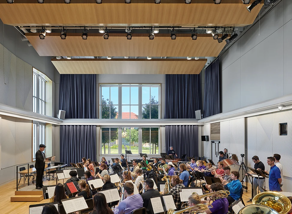 A student conducts an ensemble in the Boschini Music Center