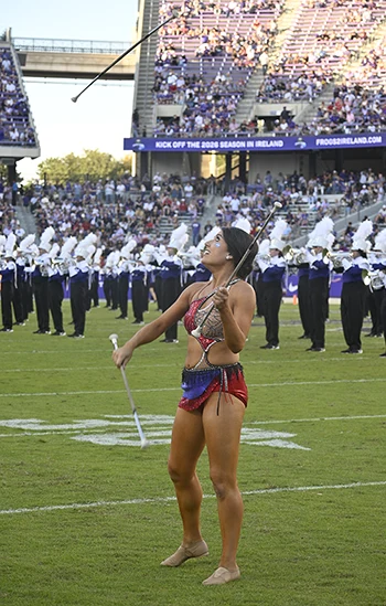 TCU feature twirler performs a 3-baton trick during a halftime performance