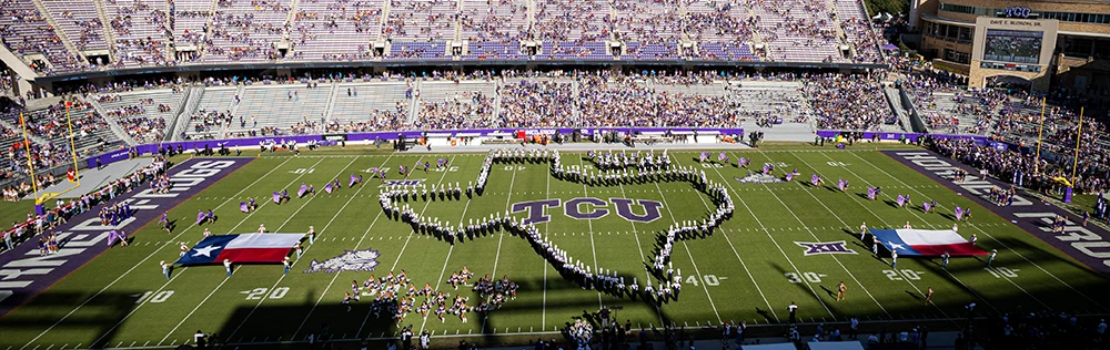 TCU Marching Band forms the shape of Texas around the TCU logo during a halftime performance
