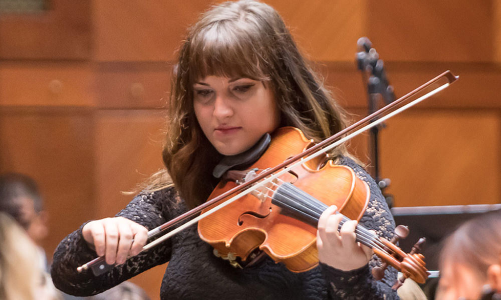 student playing a viola during a performance