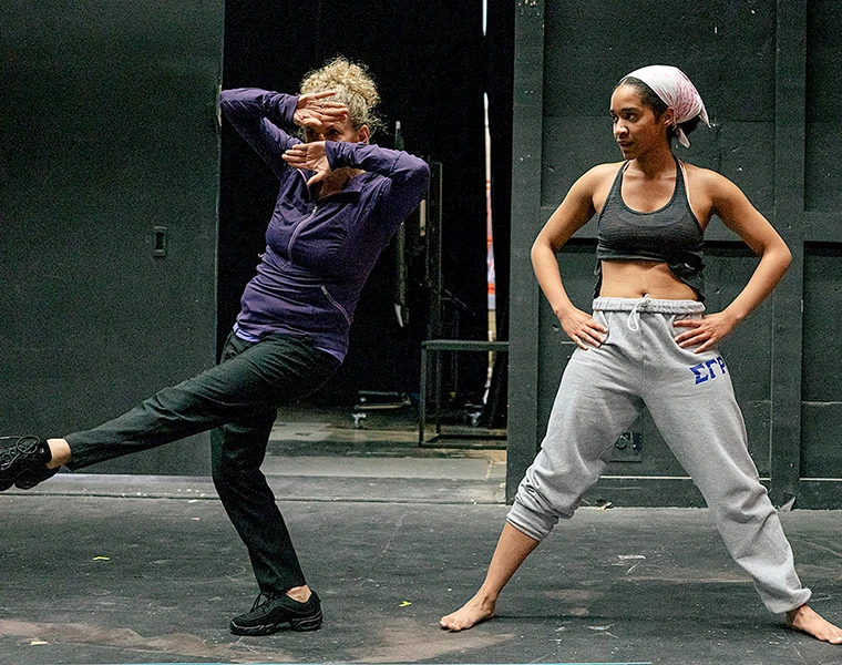 Suki John demonstrates a dance sequence for Kira Daniel