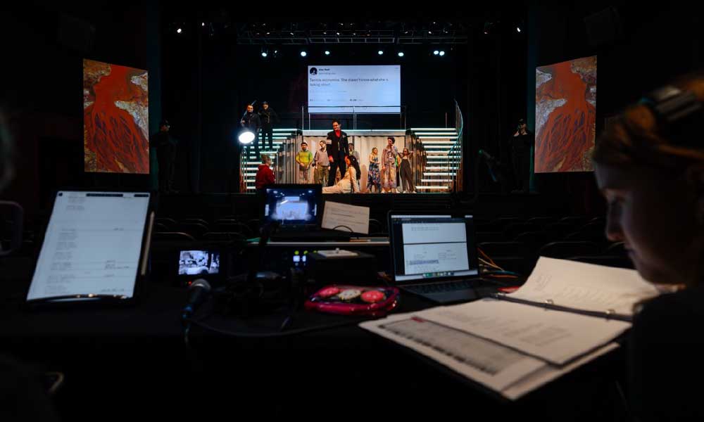 Student monitoring stage production at a theatre performance